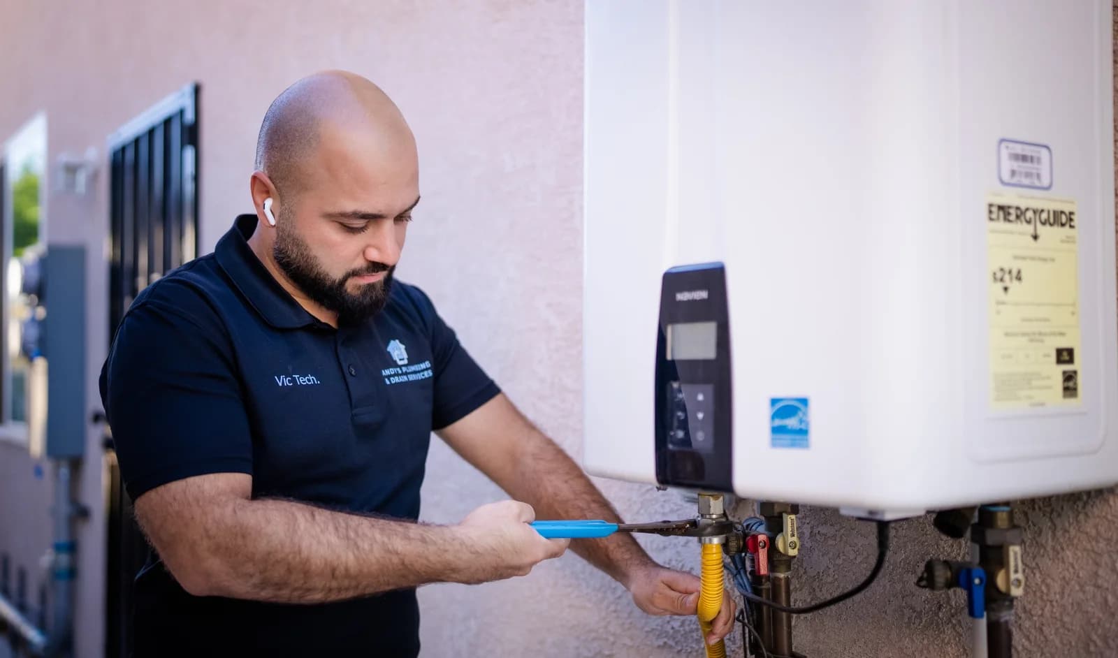 Andy's Plumbing technician servicing a tankless water heater in Los Angeles