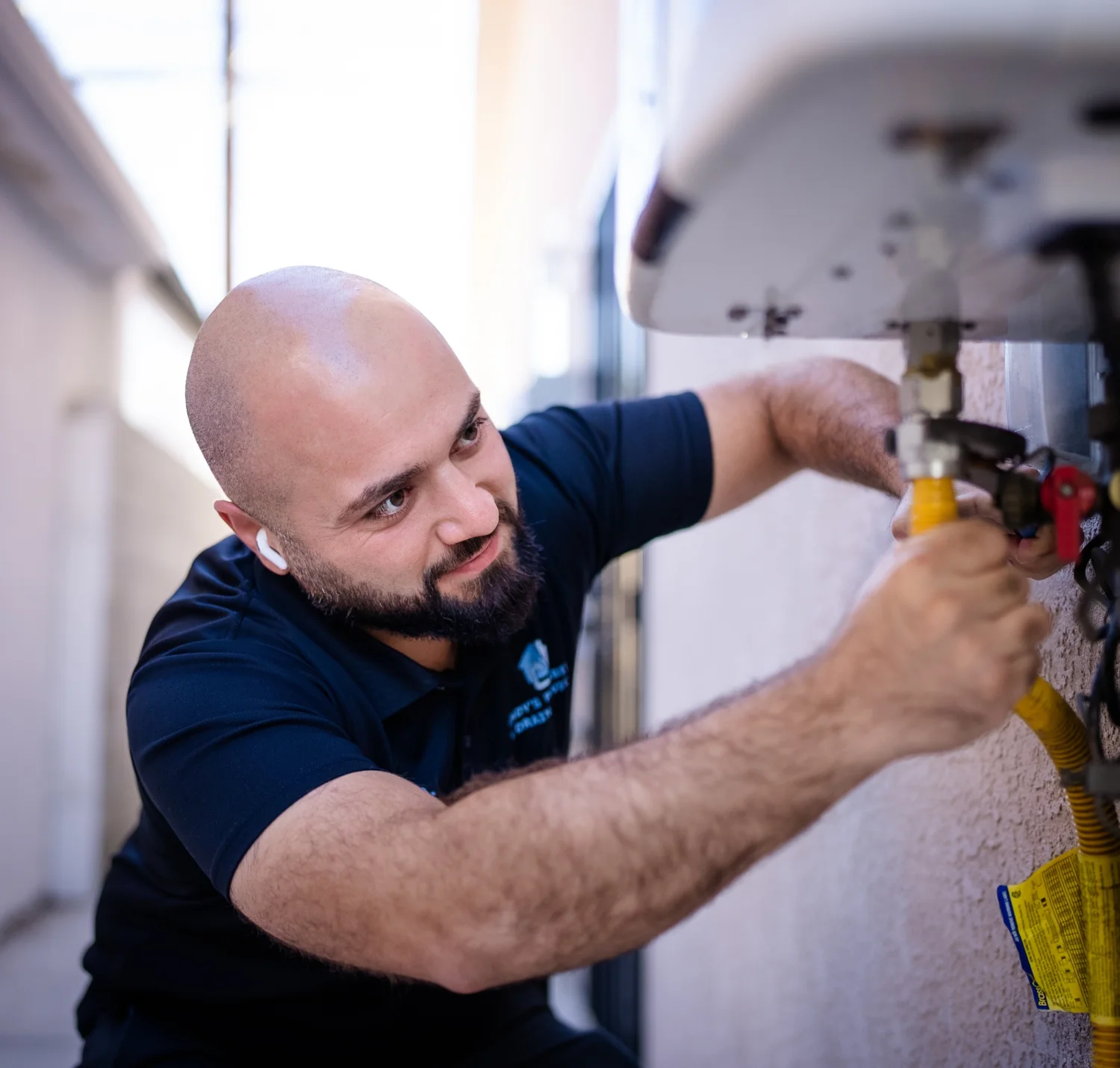 Andy's Plumbing technician servicing a tankless water heater in Los Angeles